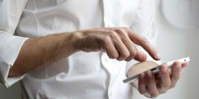 person holding white Android smartphone in white shirt